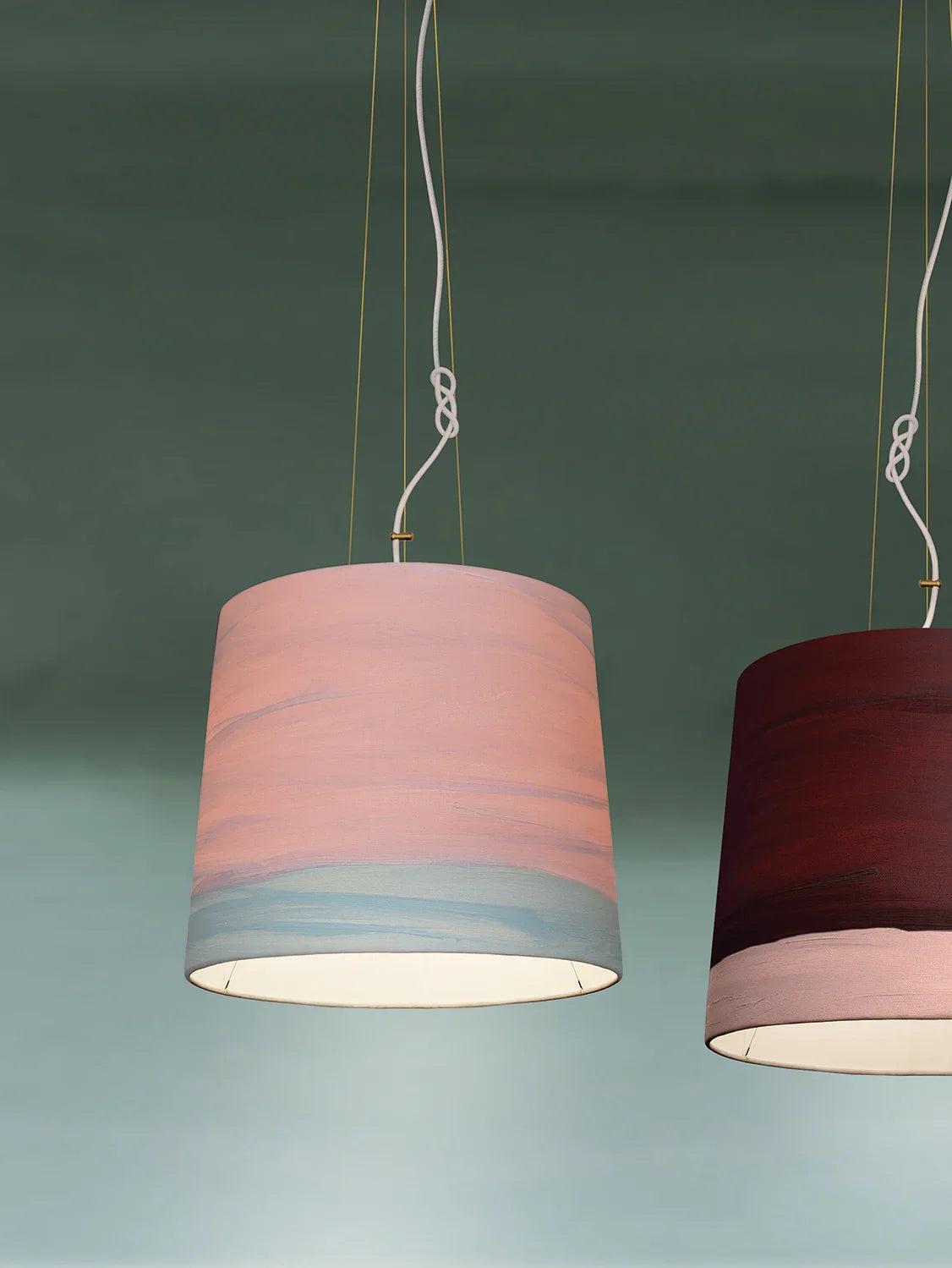 Mammalampa Sisters Pendant Light Medium in Blossom, pink and pale blue shade hanging beside a burgundy shade