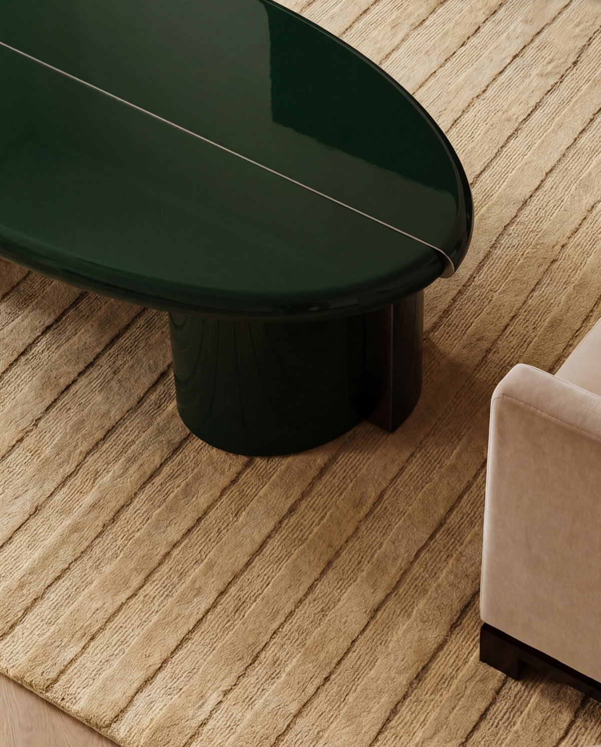 Tayma Coffee Table in Bottle Green on a striped rug beside a sofa