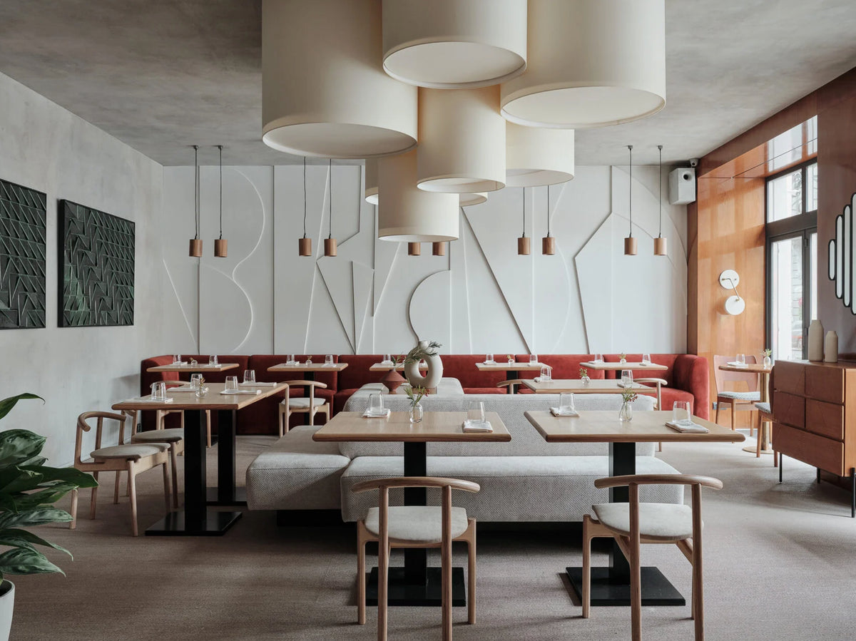 Tejo Panel pair in Jade on the wall of a dining room with pendant shades
