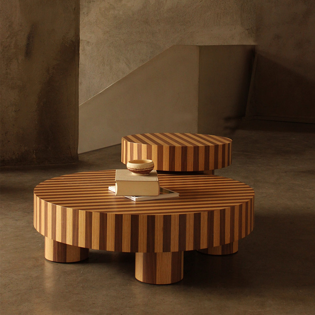 Nusa Side Table stacked over a larger low table on a polished concrete floor