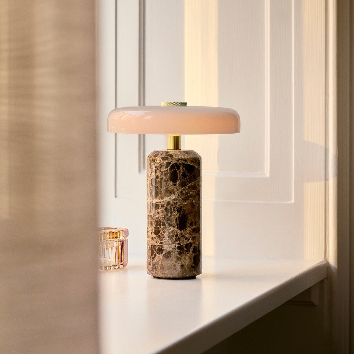 Trip Table Lamp in Dark Emperador / Opal on a sunlit windowsill