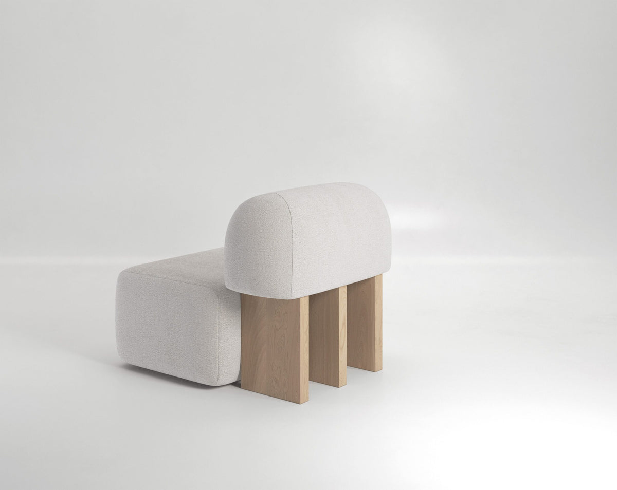 Yemeni Lounge Chair in white boucle, rear three-quarter view of the oak slab legs