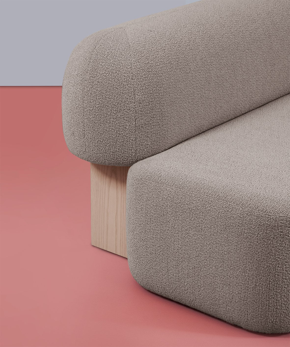 Yemeni Sofa close-up of the rounded bouclé back and blond wood leg