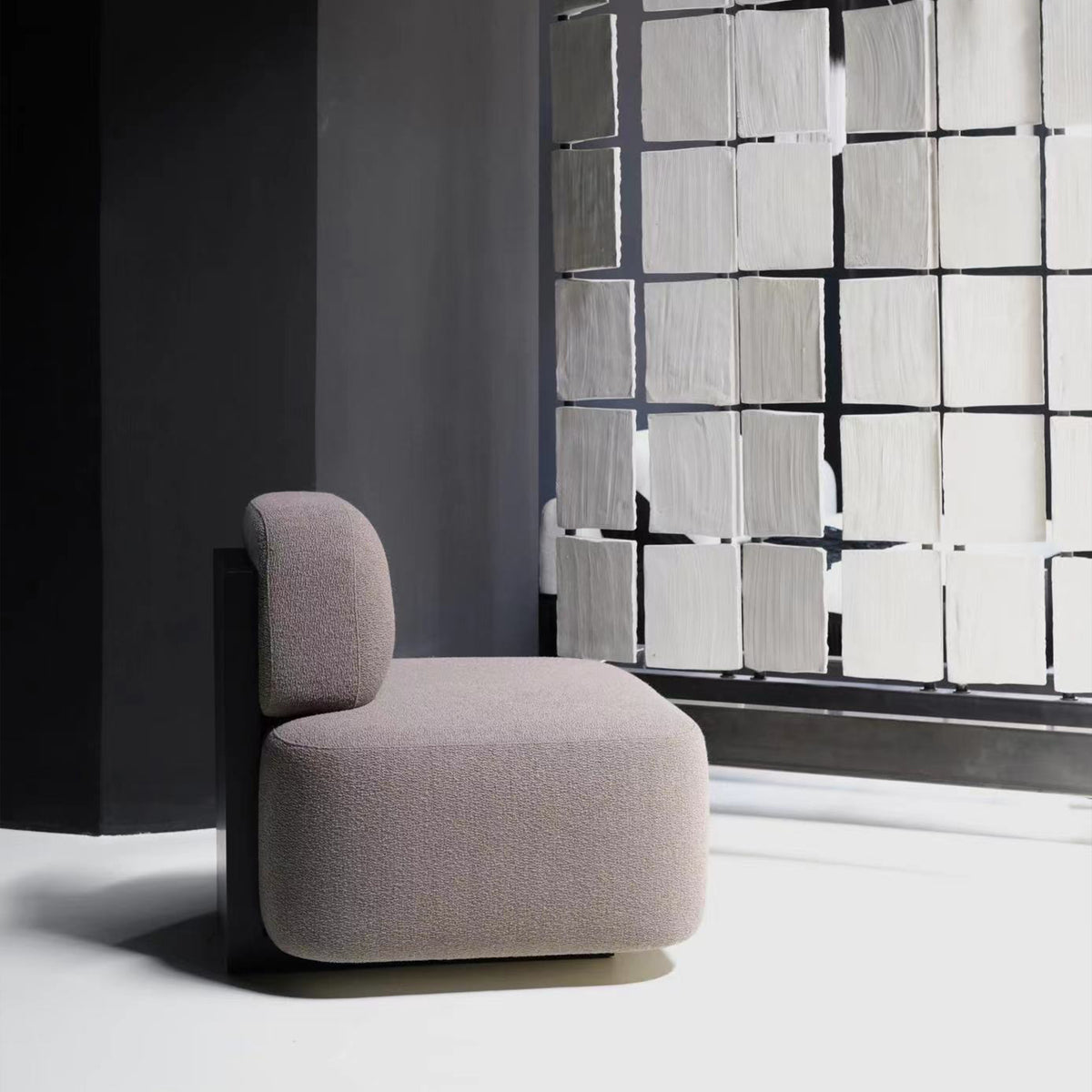 Yoshida Lounge Chair in taupe weave, side view by a frosted glass wall