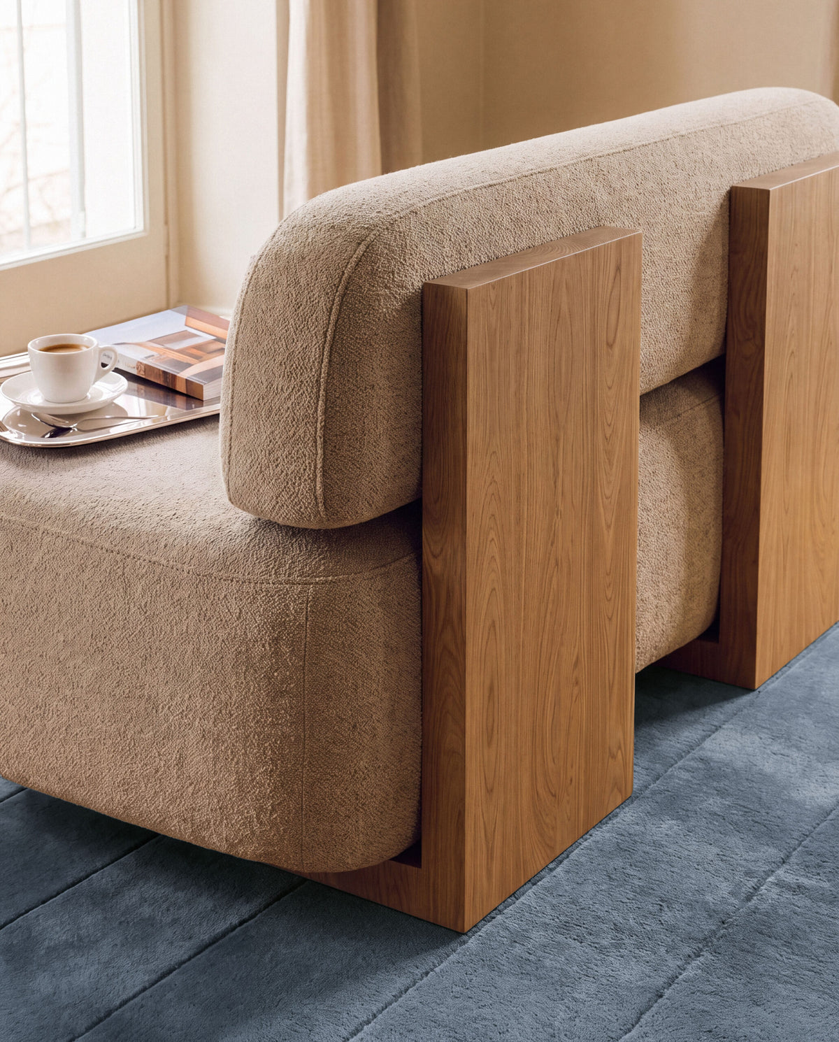 Yoshida Sofa in sand bouclé back view by a window with a tray
